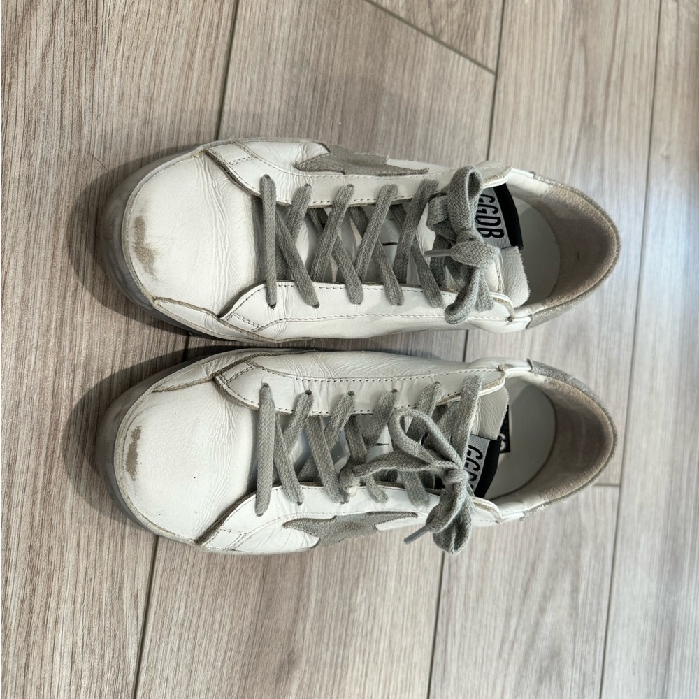 Golden Goose superstar with silver sparkle foxing and metal stud lettering